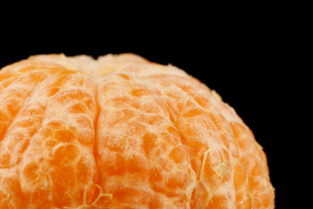 Peeled healthy tangerine fruit close-up on a black backgroundの写真素材