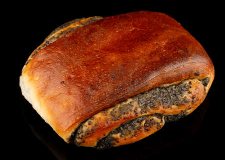 Bun with poppy seeds and muffins on a black backgroundの写真素材