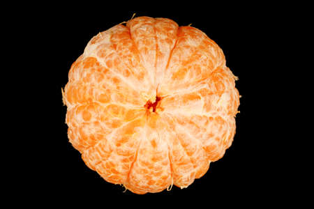 Peeled healthy tangerine fruit close-up on a black backgroundの写真素材
