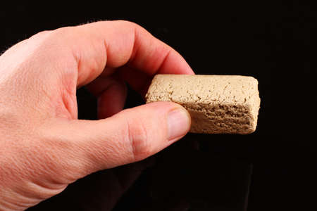 halvah in hand on black backgroundの写真素材