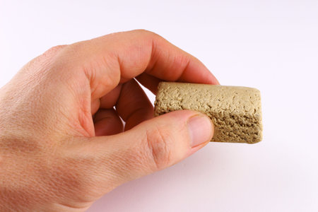 halvah in hand on a white backgroundの写真素材