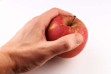 Red apple Fuji grade on a white background in handの写真素材