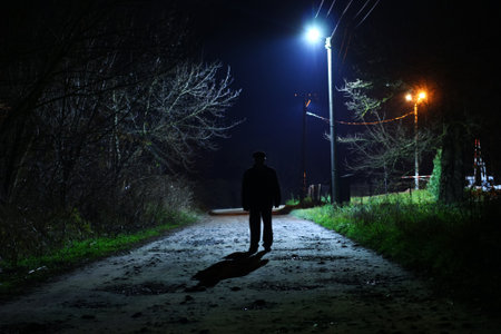 An unknown man on a dark street as a criminal and a thugの写真素材