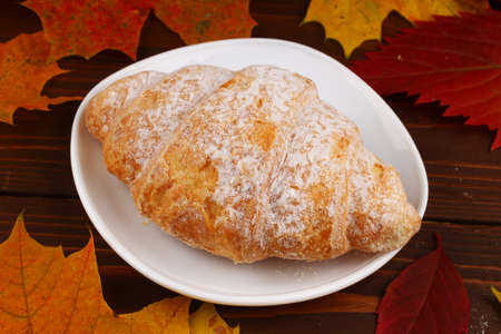 Croissant on the plate autumn still lifeの写真素材