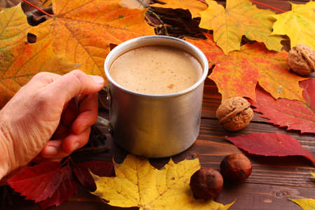 Autumn still life with a cup of cappuccinoの写真素材