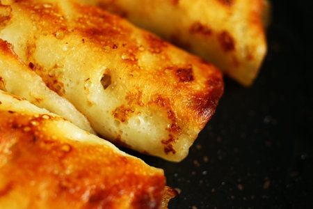 Pancakes stuffed with frying in a frying panの写真素材