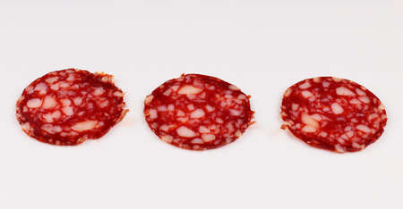 Red sausage sliced on a white backgroundの写真素材