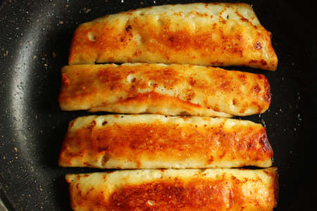Pancakes stuffed with frying in a frying panの写真素材