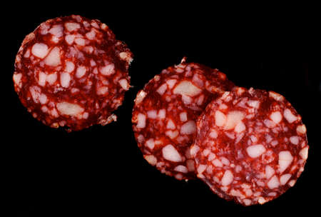 Red sausage sliced on black backgroundの写真素材