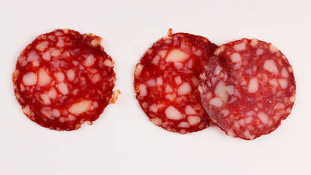Red sausage sliced on a white backgroundの写真素材