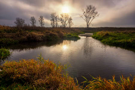 Beautiful autumn lake landscape on a cloudy dayの写真素材