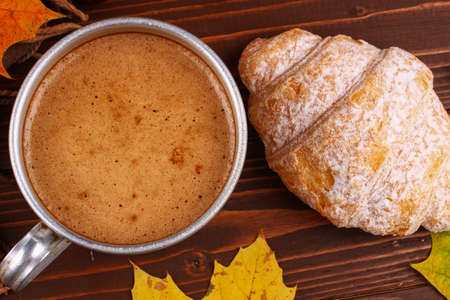 Cup of cappuccino and croissant autumn still life closeupの写真素材