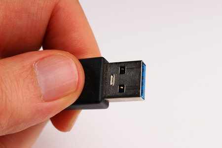 usb cable In the hand on a white background closeupの写真素材