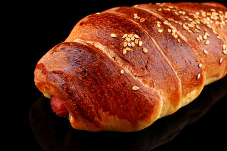 Bun with sausage on a dark backgroundの写真素材