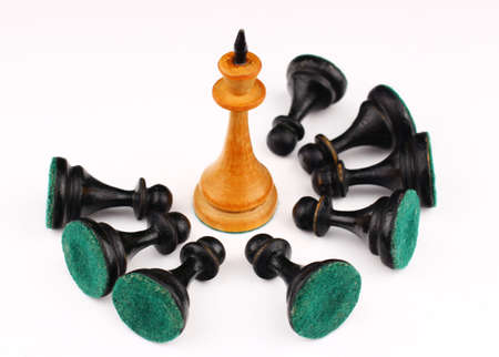 White chess king and black pawns on lap on a white backgroundの写真素材