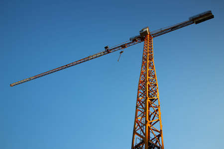 Construction crane on blue sky backgroundの写真素材