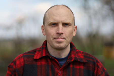 Confident middle-aged peasant man and plaid shirtの写真素材