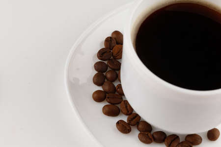 Coffee in cup and grains close-up isolateの写真素材