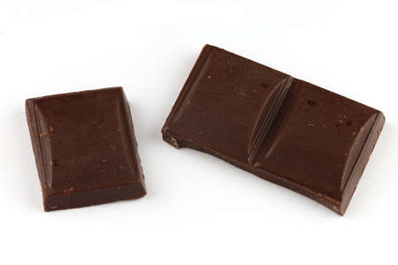Pieces of dark chocolate on a white background isolateの写真素材