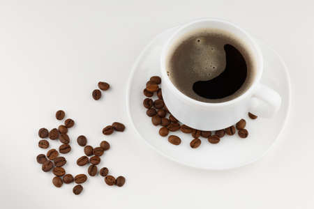 Coffee drink in white cup and grain isolateの写真素材
