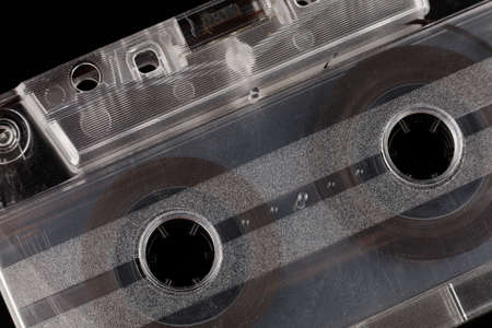 Old audio cassette on a black background close-up
