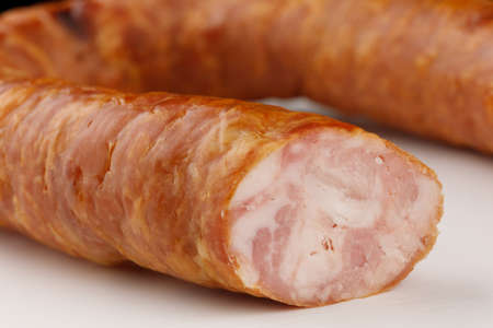 Appetizing sausage on a white background close-upの写真素材