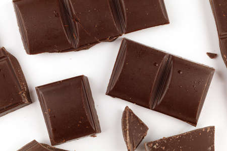 Pieces of dark chocolate on a white background isolateの写真素材