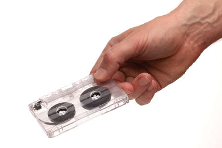 Old audio cassette in hand on a white backgroundの写真素材