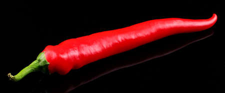 Red hot chili pepper on a black background