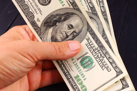 American money 100 dollars in hand close-upの写真素材