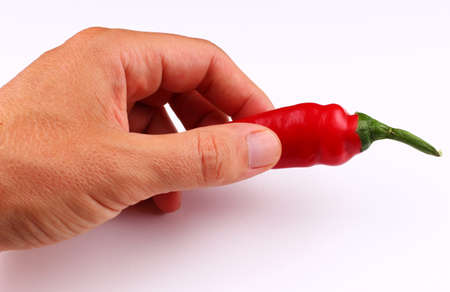 Red hot chili pepper in hand isolateの写真素材