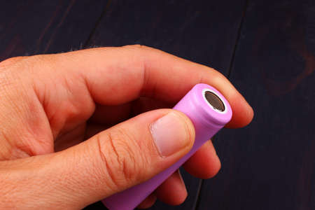 The 18650 battery in the hand is a popular batteryの写真素材
