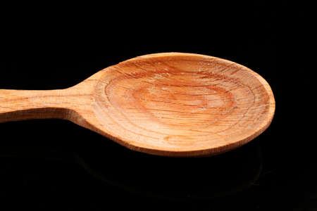 Wooden spoon on black background close upの写真素材