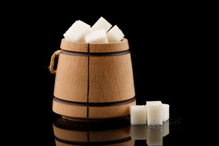 Many pieces of white sugar in a wooden barrelの写真素材