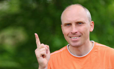 A white man points a finger at a place for textの写真素材