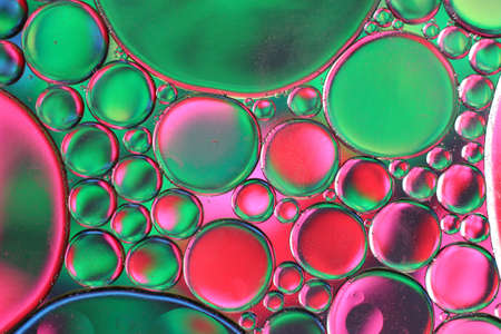 Colored drops of oil on the water. Background or texture.の写真素材