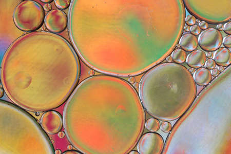 Colored drops of oil on the water. Background or texture.の写真素材