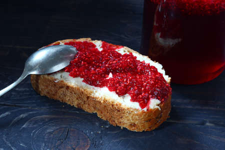 Traditional food. Raspberry jam and bread with butter.の写真素材
