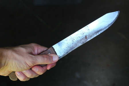 Knife in the hands of a criminal or murderer.の写真素材