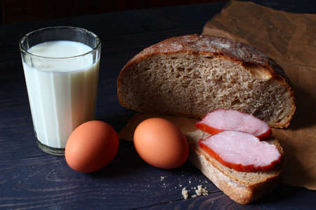 Simple rustic food. Eggs, bread, milk and ham.の写真素材