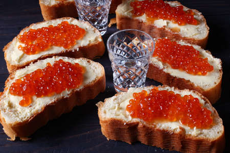 Sandwiches with red caviar and vodka.の写真素材