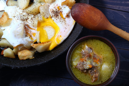 Rustic food from simple products. Soup, eggs and wine.の写真素材