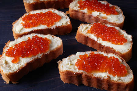 Sandwiches with red caviar on a dark backgroundの写真素材
