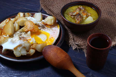 Rustic food from simple products. Soup, eggs and wine.の写真素材