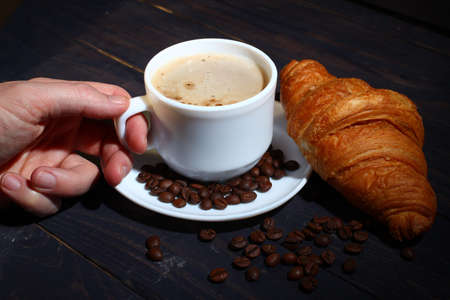 Cappuccino in a cup and croissant. Popular breakfast.の写真素材