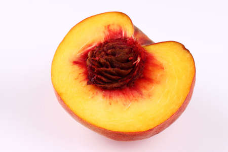 Half of peach on a white background close upの写真素材