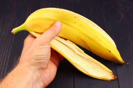 Banana peel in hand close upの写真素材