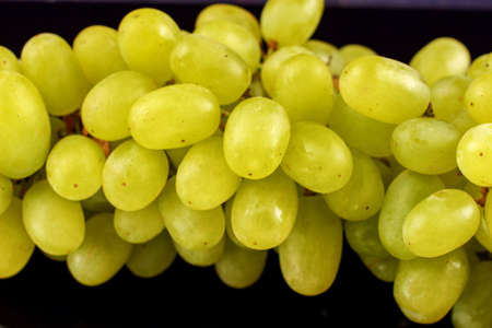 yellow grape Sultana Thompson Seedless Kishmish on black backgroundの写真素材