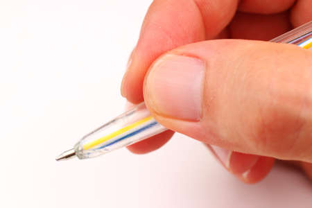 Hand and pen on a white backgroundの写真素材