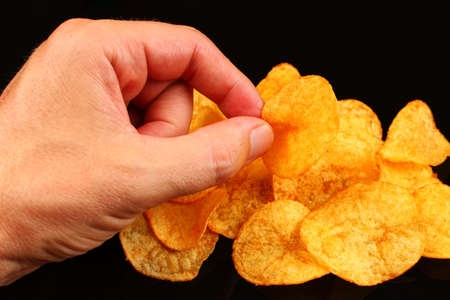 Potato chips on a black backgroundの写真素材